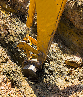 excavating a hole for septic installation